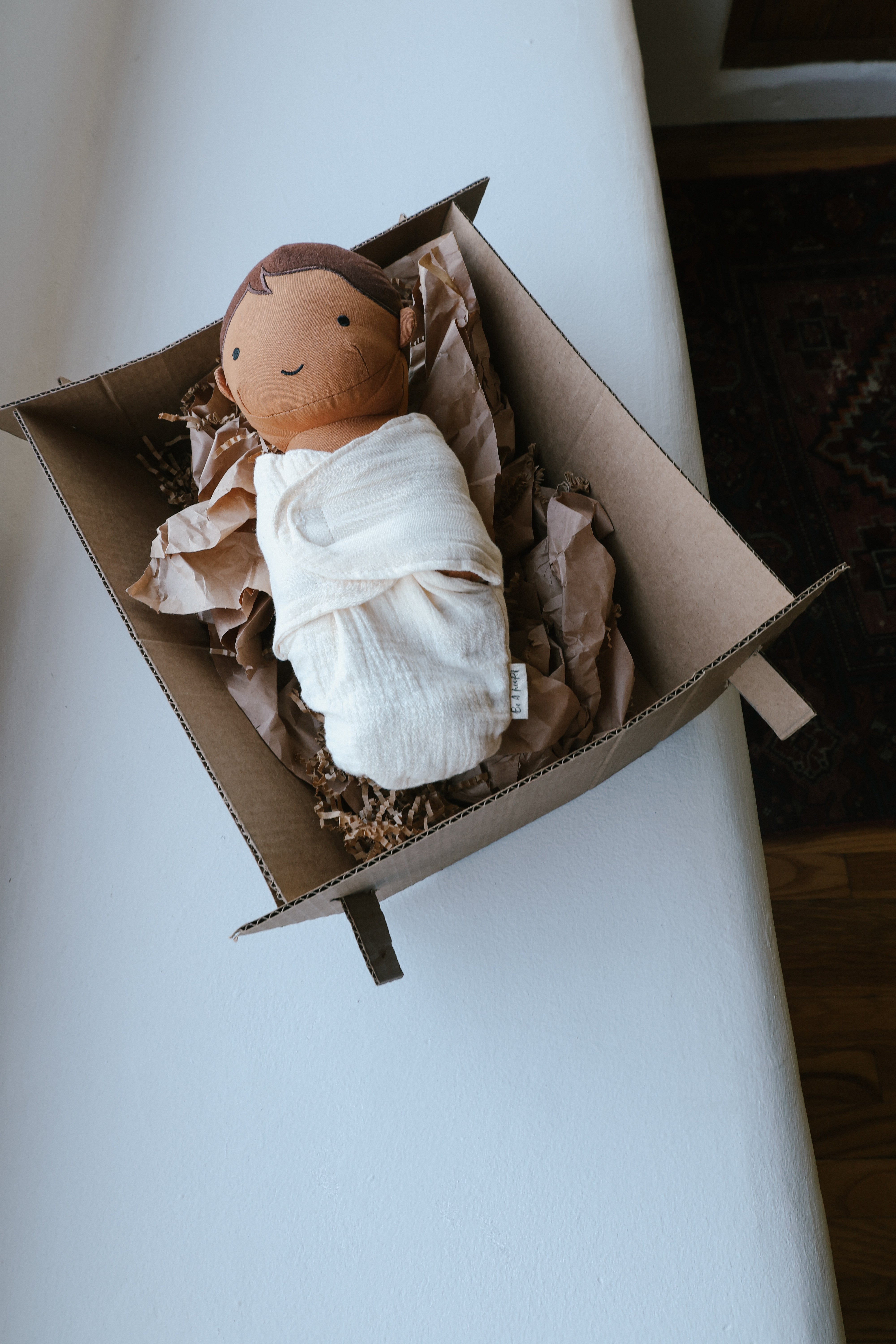 Stuffed baby Jesus doll with soft fabric blanket and diaper, designed for cuddling and play.