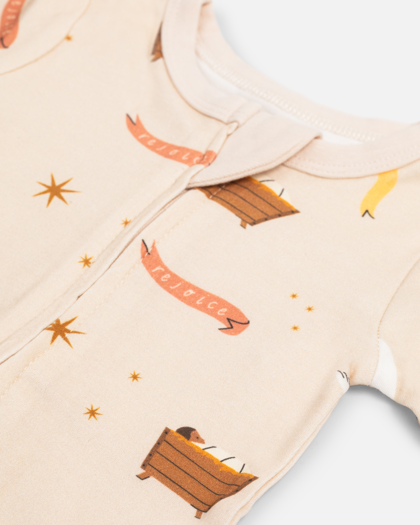 Children’s Christmas pajamas—sleeper and long john styles—with illustrations of angels, baby Jesus in the manger, and doves.