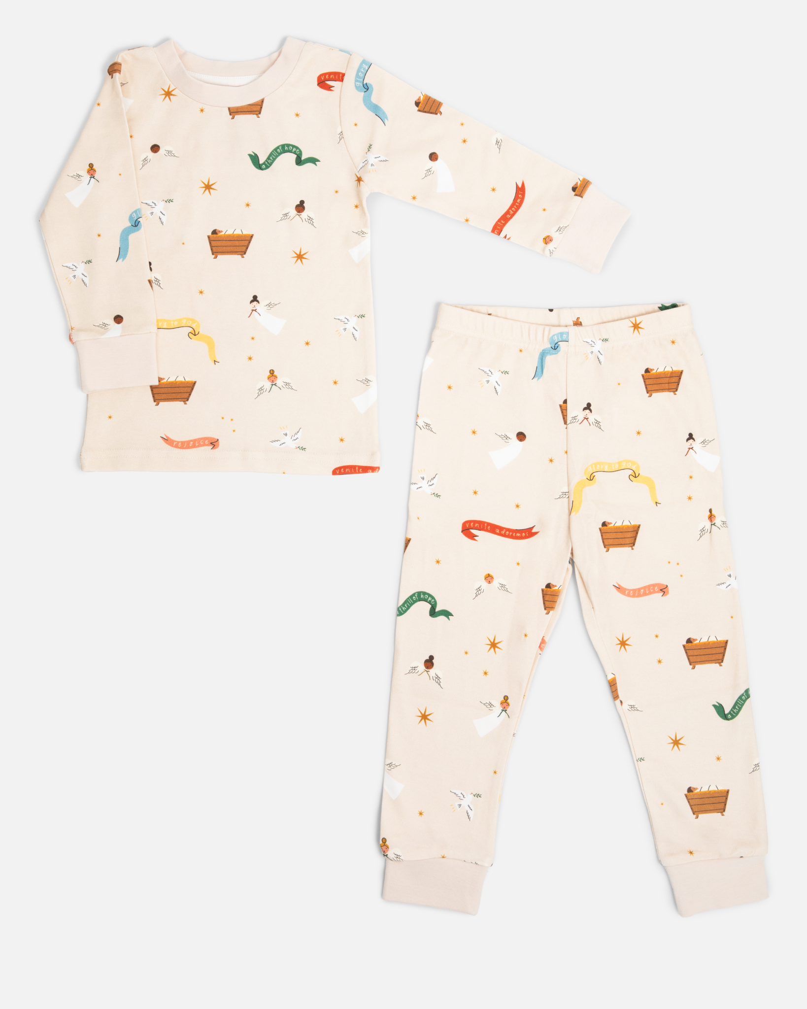 Children’s Christmas pajamas—sleeper and long john styles—with illustrations of angels, baby Jesus in the manger, and doves.