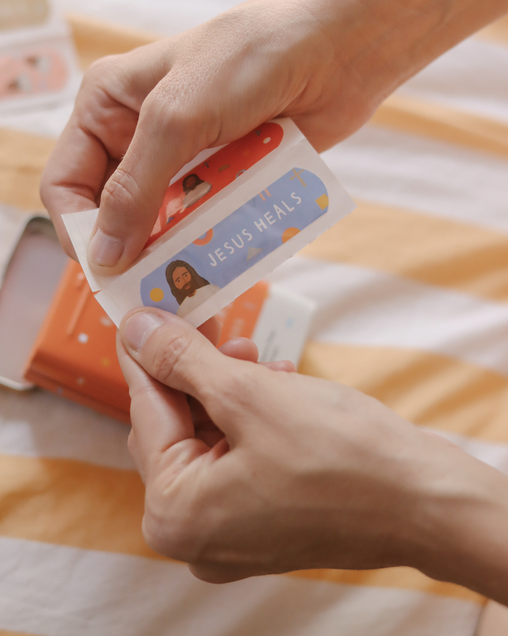 Jesus Heals Bandages for kids and adults, 40 sterile adhesive strips with 5 faith-inspired designs in reusable tin. Latex-free, water-resistant Christian bandages serving as a spiritual reminder that Jesus is the Healer—perfect for faith-based gifts, church events, or everyday use.