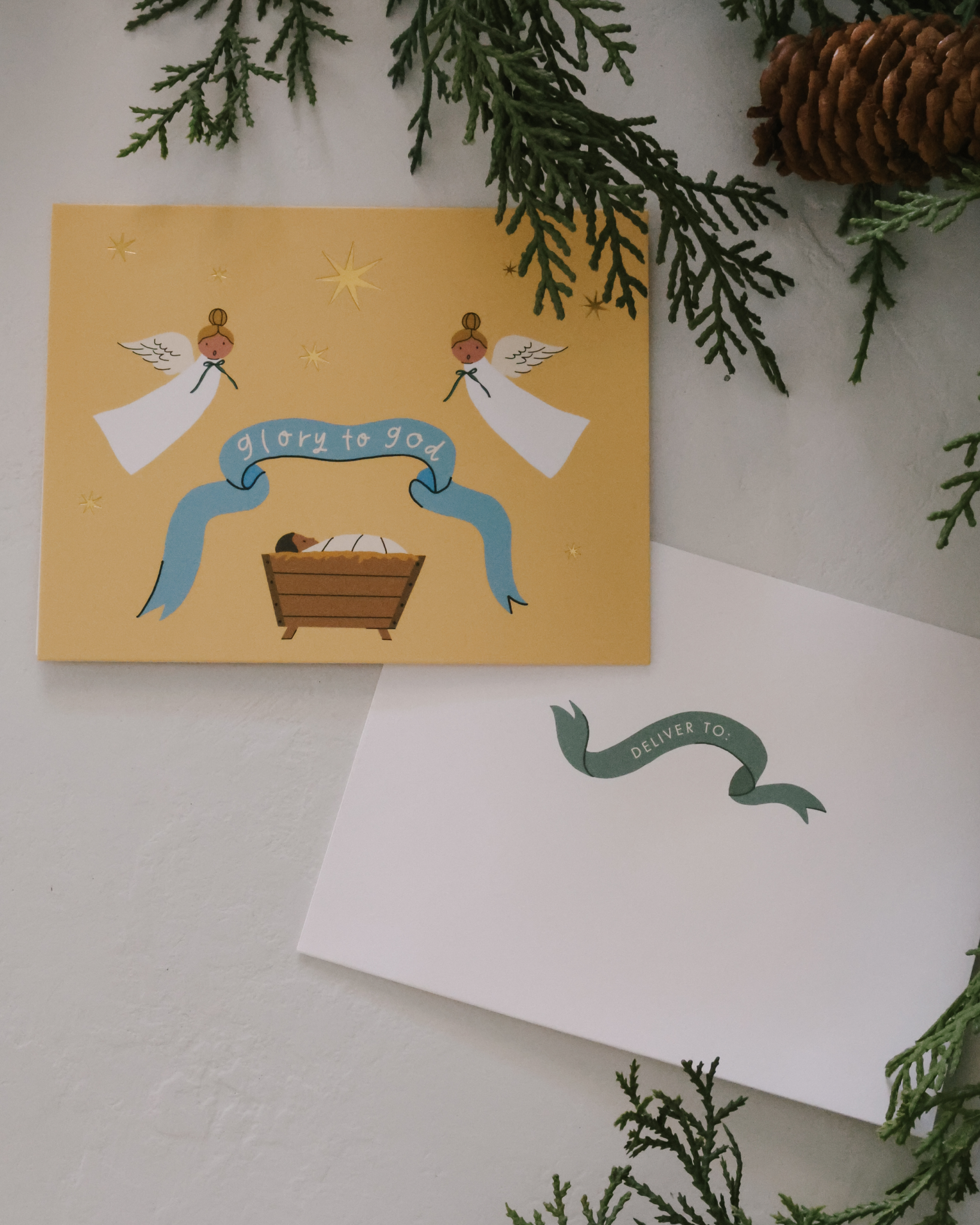 Christian Christmas card set with gold-foil Nativity illustrations featuring baby Jesus in the manger, angels, Holy Family, and starry sky. Includes 12 religious Christmas cards with envelopes in a keepsake box—perfect for faith-based holiday greetings and Christ-centered Christmas traditions.