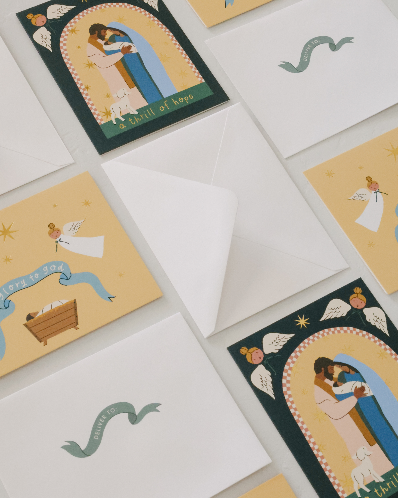 Christian Christmas card set with gold-foil Nativity illustrations featuring baby Jesus in the manger, angels, Holy Family, and starry sky. Includes 12 religious Christmas cards with envelopes in a keepsake box—perfect for faith-based holiday greetings and Christ-centered Christmas traditions.