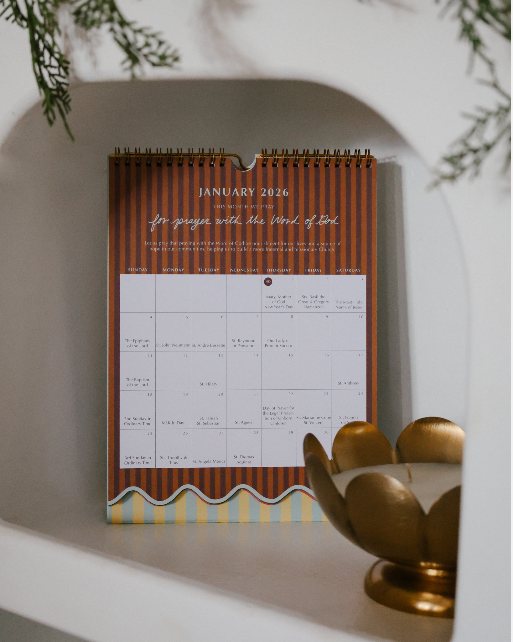 2026 Catholic liturgical calendar with colorful stripes, monthly prayers by Pope Francis, and all feast days and US holidays. Available as wall calendar or wall + desk stand combo.