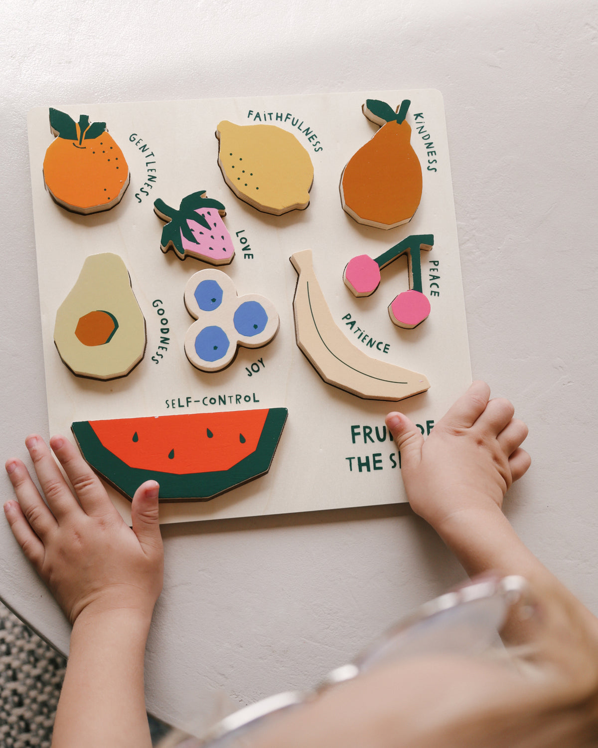 Completed Fruit of the Spirit puzzle with each fruit labeled love, joy, peace and patience