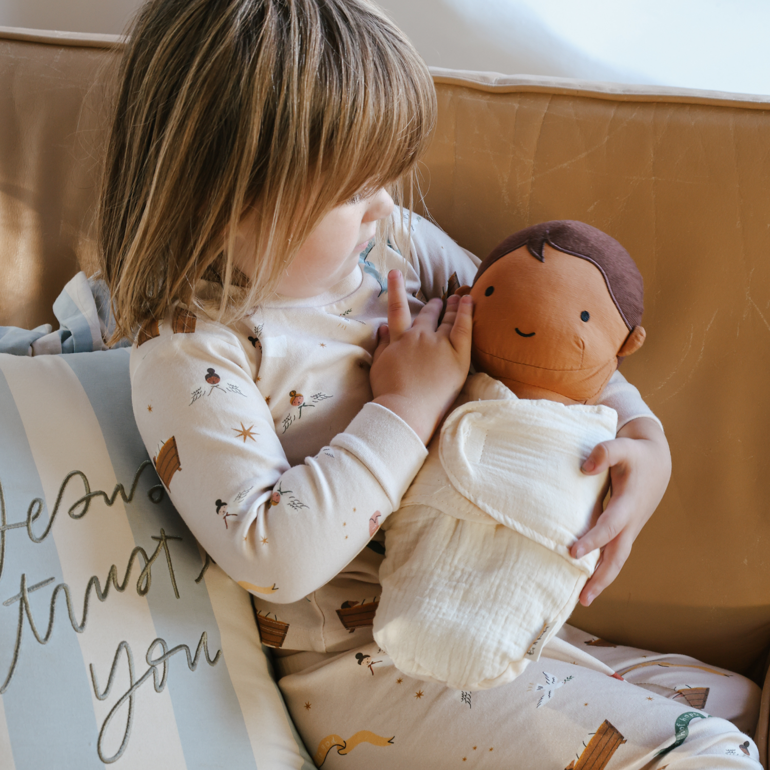 Stuffed baby Jesus doll with soft fabric blanket and diaper, designed for cuddling and play.