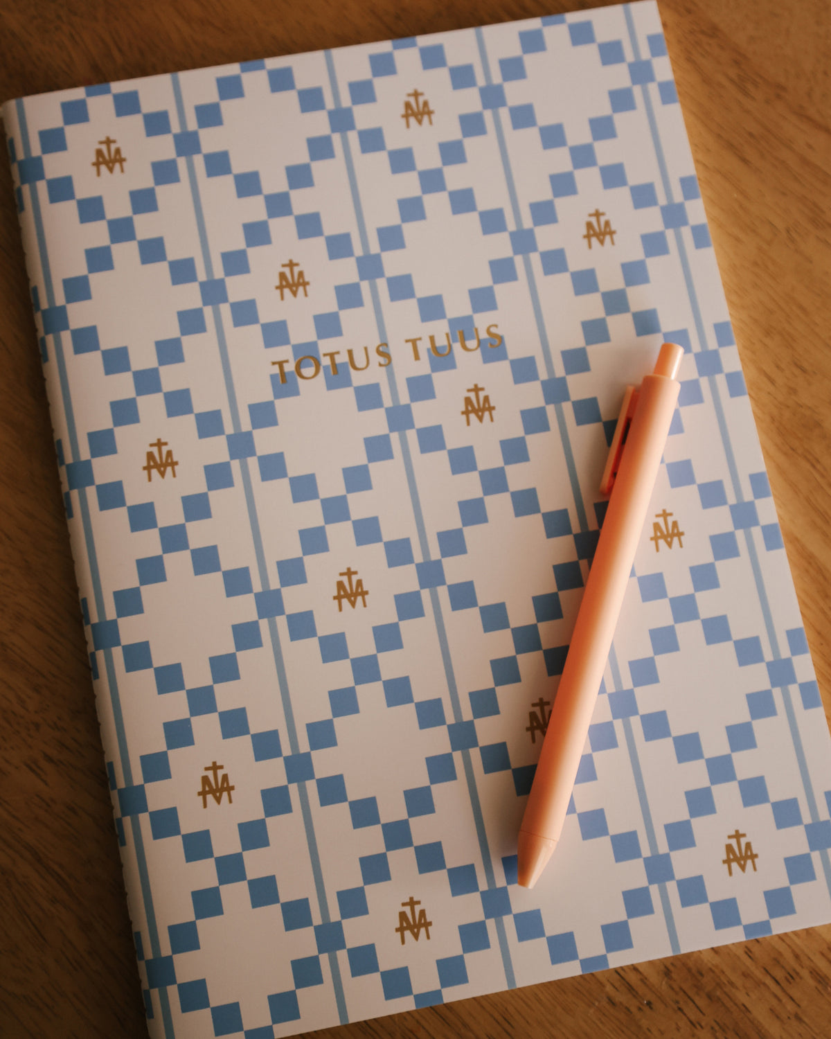 Marian Cross Journal with Totus Tuus on the cover and a pen