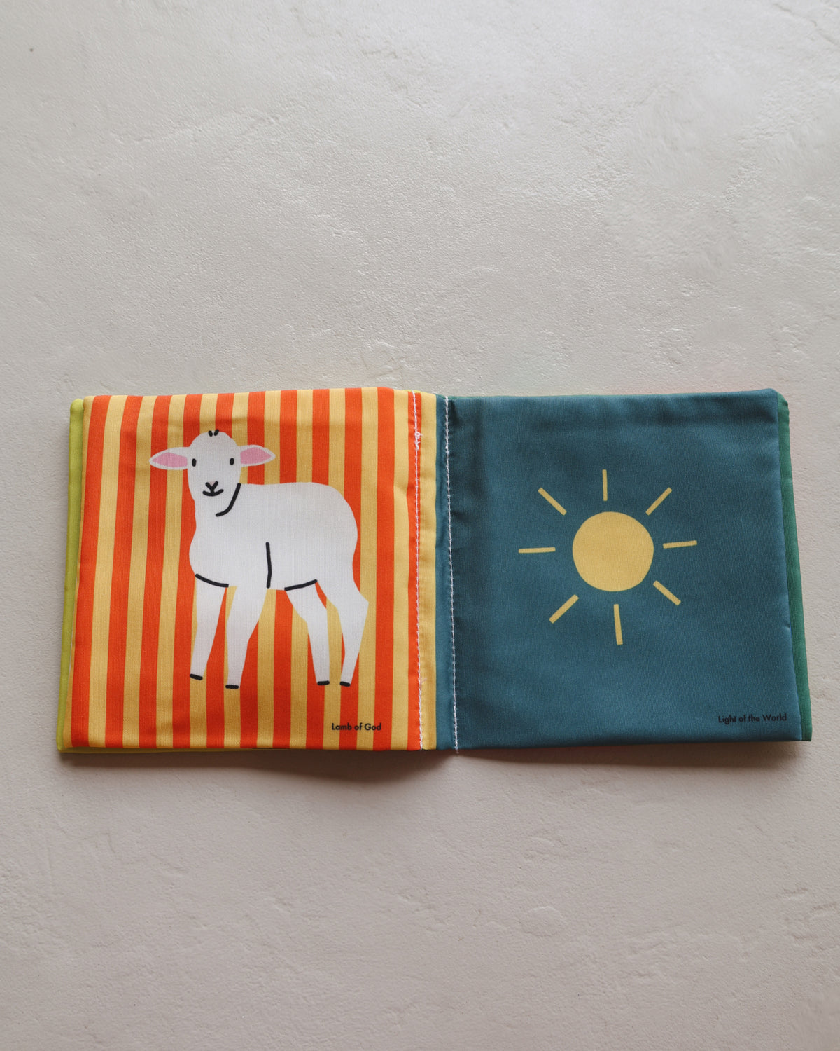 Lamb and sun pages in Baby's First Book of Jesus, a high contrast Christian baby book