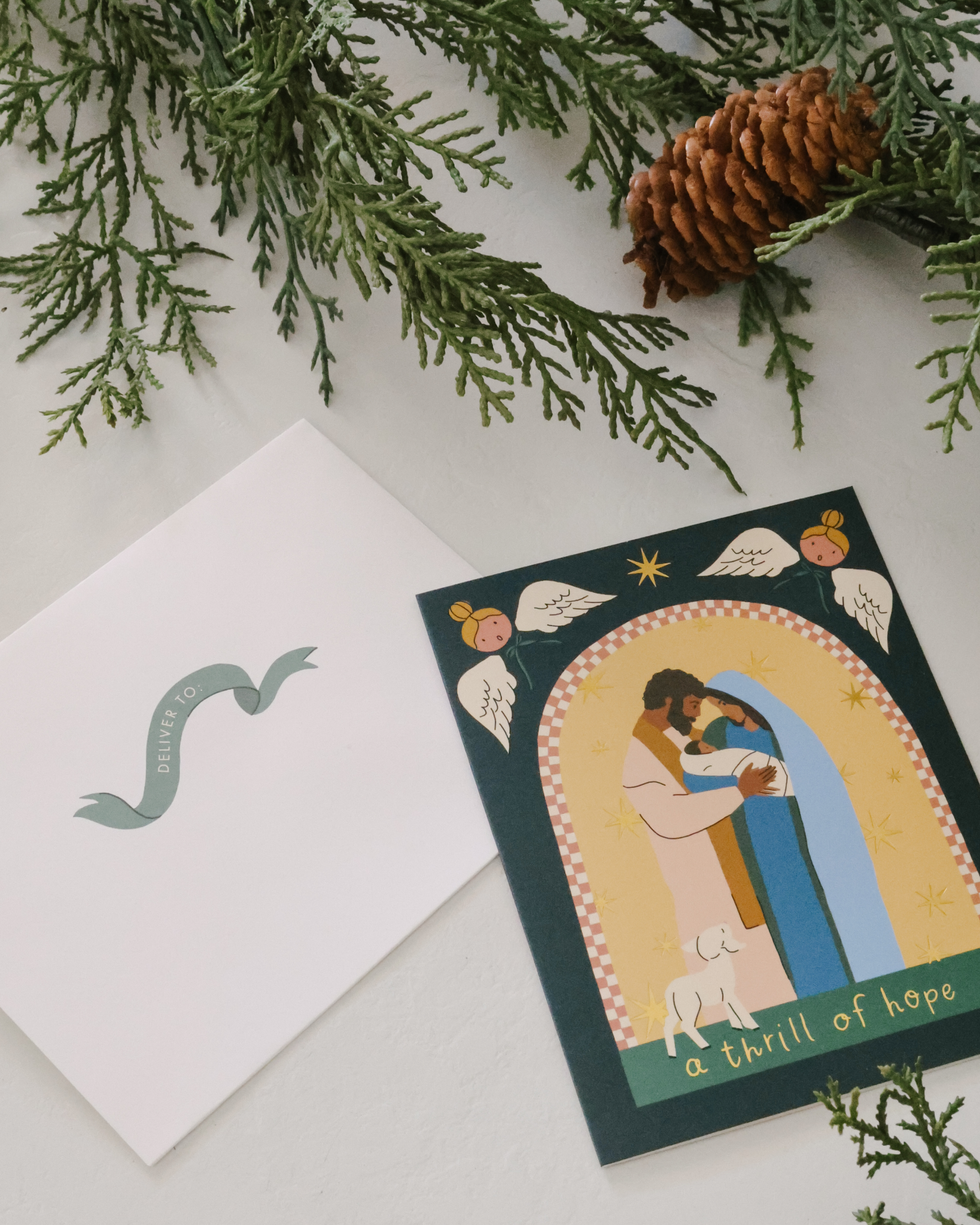 Christian Christmas card set with gold-foil Nativity illustrations featuring baby Jesus in the manger, angels, Holy Family, and starry sky. Includes 12 religious Christmas cards with envelopes in a keepsake box—perfect for faith-based holiday greetings and Christ-centered Christmas traditions.