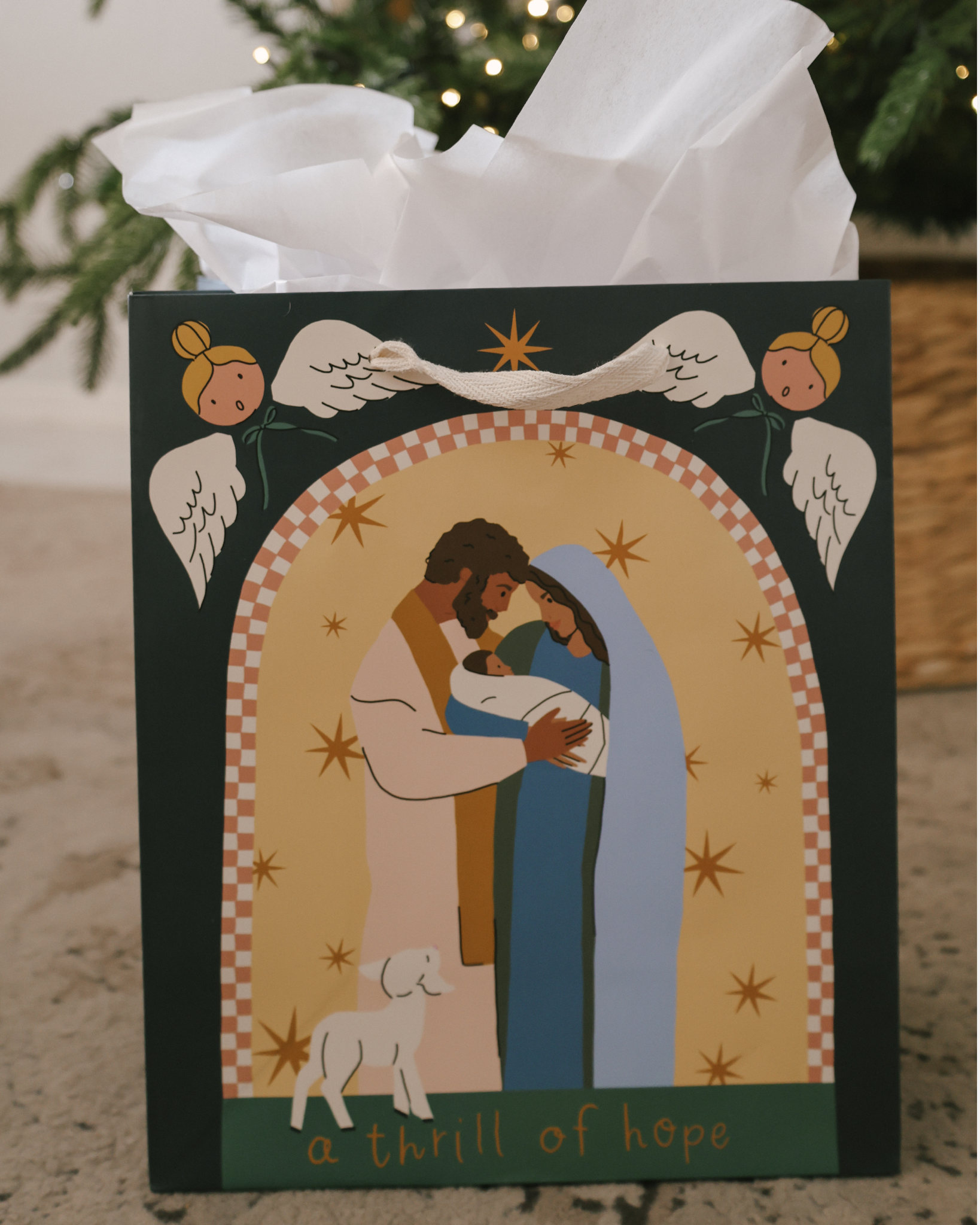 A Thrill of Hope Christmas gift bag set with Nativity illustration of Mary, Joseph, and baby Jesus, angels, and starry sky. Includes 5 bags in 3 sizes with cotton ribbon handles and matching gift tags.