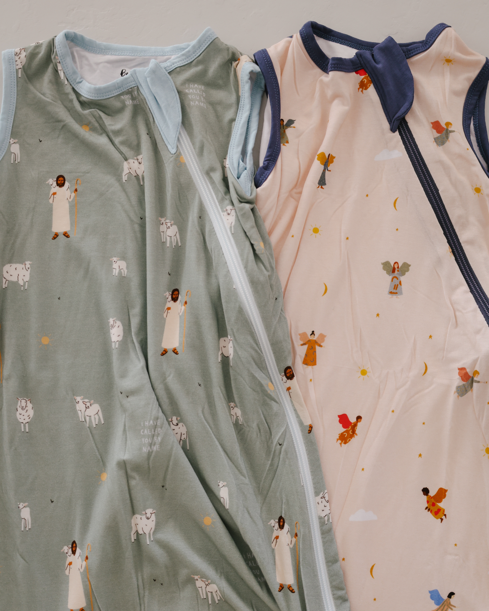 Faith-inspired baby sleep sacks with Guardian Angel and Good Shepherd designs, made from soft bamboo blend with double zippers. Christian wearable blankets for newborns and infants, providing safe, cozy, and faith-based bedtime comfort while reminding little ones of God’s protection and Jesus’ love.