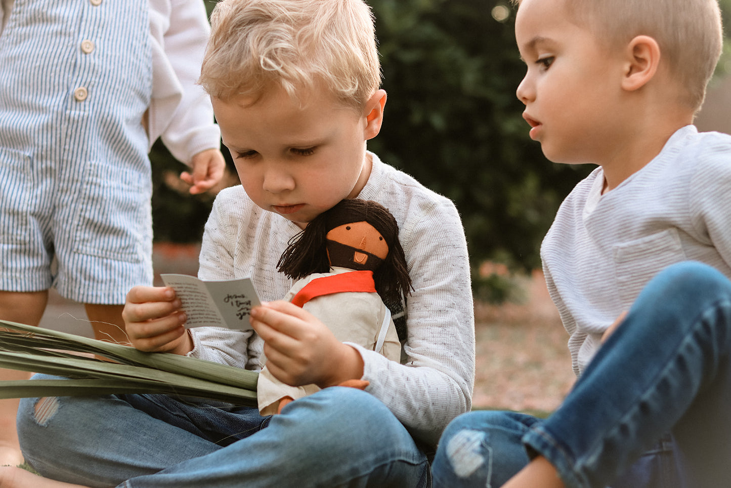 alt="Toddlers playing Jesus of Nazareth Doll"