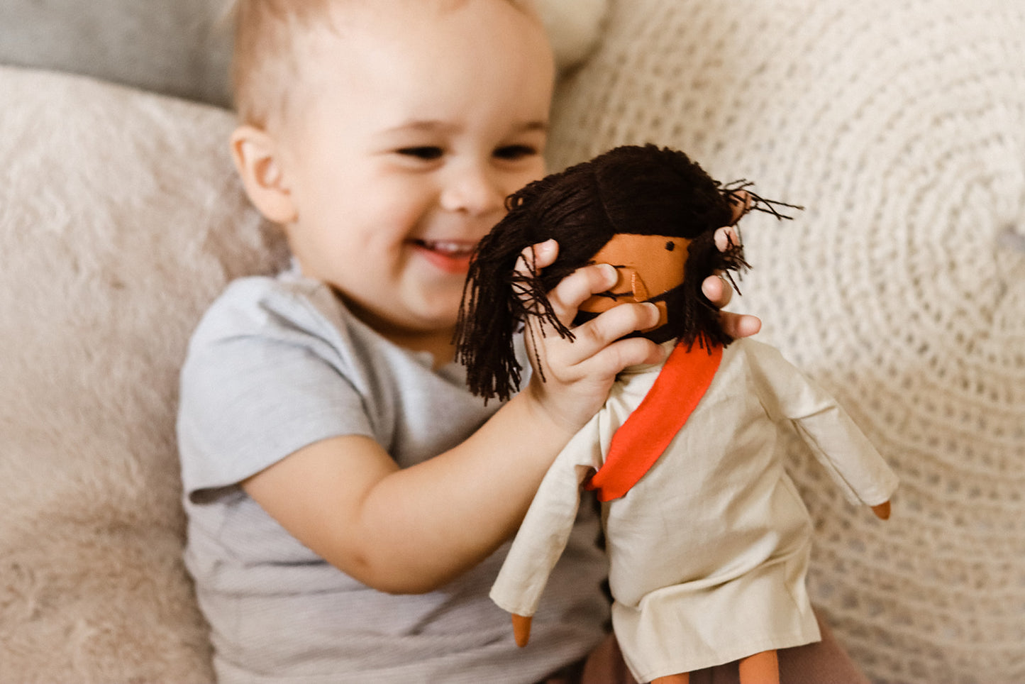 alt="Toddler playing Jesus of Nazareth Doll"